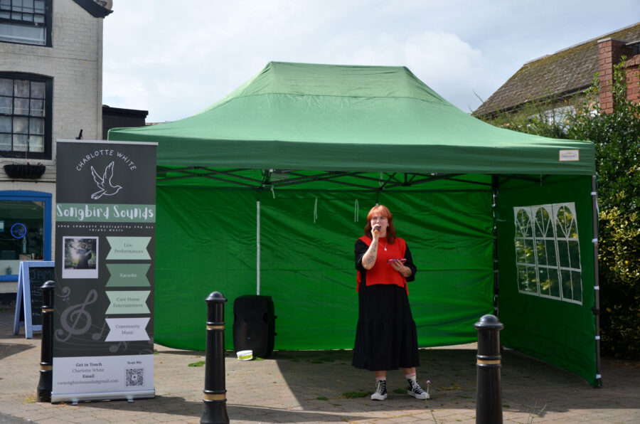 Charlotte White performing at New Street Corner on Honiton Market Charter Day 2025