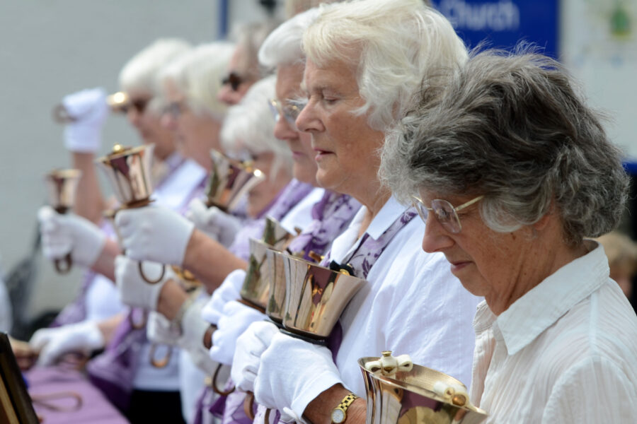 Dunkeswell Handbell Ringers performing outside St Paul's Church on Honiton Market Charter Day 2025