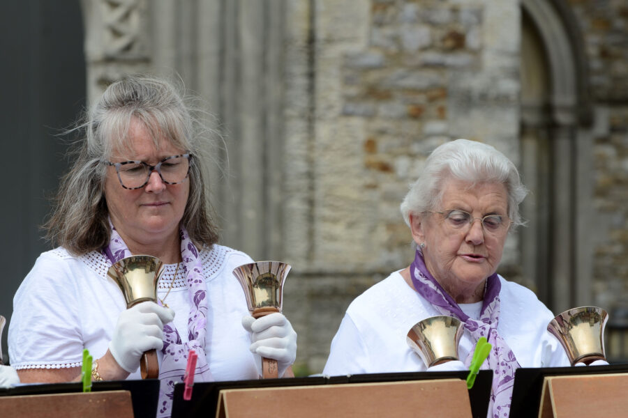 Dunkeswell Handbell Ringers performing outside St Paul's Church on Honiton Market Charter Day 2025