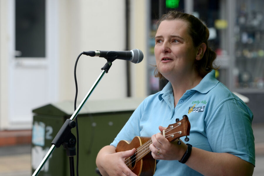 Emily Miller performing at New Street Corner on Honiton Market Charter Day 2025