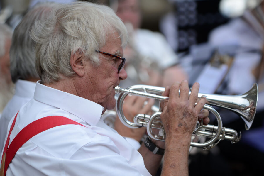 A memebr of Honiton Training Band performing outside St Paul's Church on Honiton Market Charter Day 2025