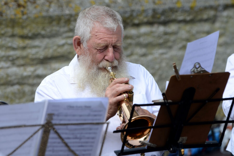 A member of Honiton Training Band performing outside St Paul's Church on Honiton Market Charter Day 2025