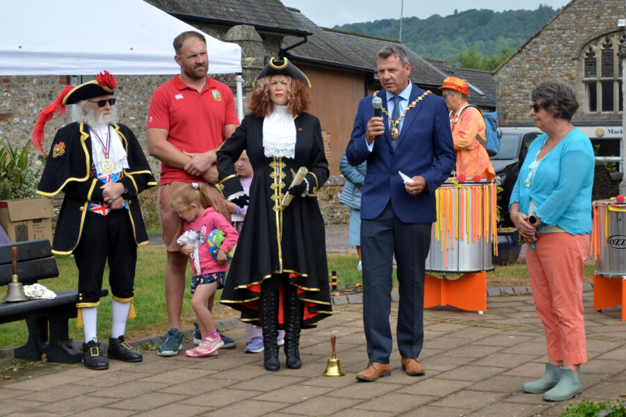 Honiton Mayor, Cllr Andrew Pearsall giving a welcome address at the opening ceremony for Honiton Market Charter Day 2025 outside St Paul's Church