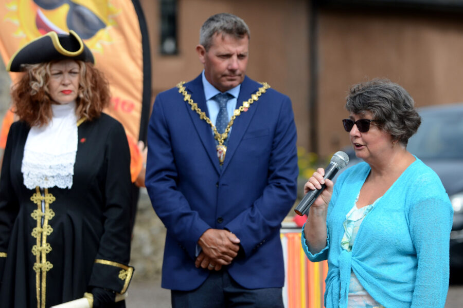 Valerie Sheen, Chair of the Honiton Market Charter Day Planning Group, speaking at the opening ceremony for Honiton Market Charter Day 2025 outside St Paul's Church