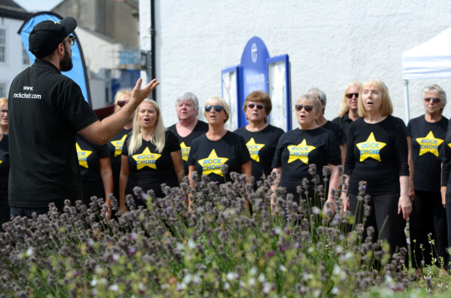 The Rock Choir performing outside St Paul's Church on Honiton Market Charter Day 2025