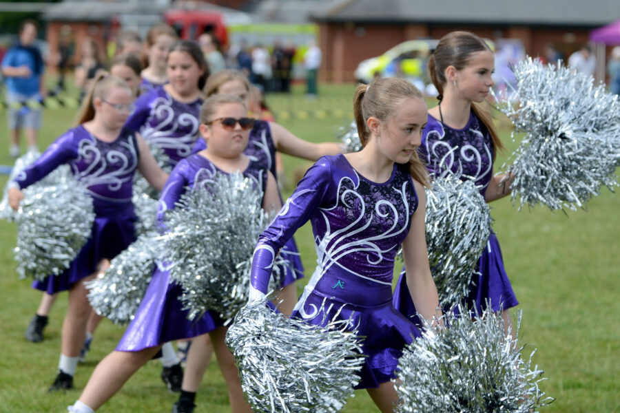 Twirlstars Majorettes performing on Allhallows Field at Honiton Market Charter Day 2025