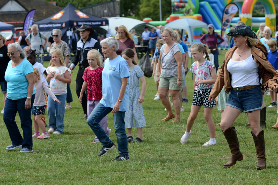 Western Spirit Line Dance Club performing on Allhallows Field at Honiton Market Charter Day 2025.